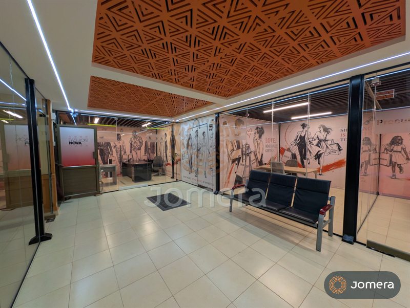 Office reception with glass partitions, CNC-cut terracotta ceiling panels, linear LED lighting and a waiting bench